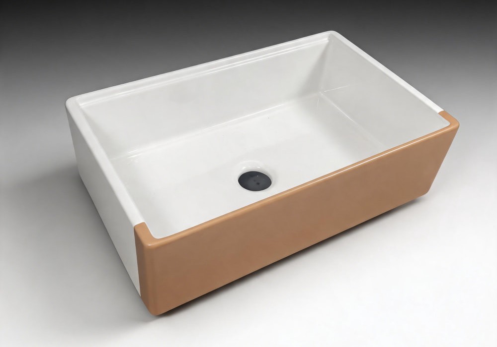 Fireclay farmhouse sink with a warm tan matte apron and a white interior bowl, three-quarter view